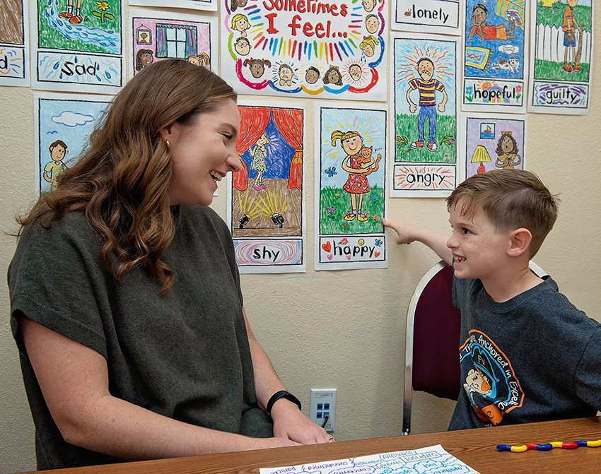 Childhood mental health counselor works with student